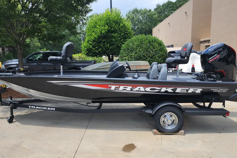 The Image of 2026 Tracker Pro Team 190 boat on trailer, parked outdoors. - 0