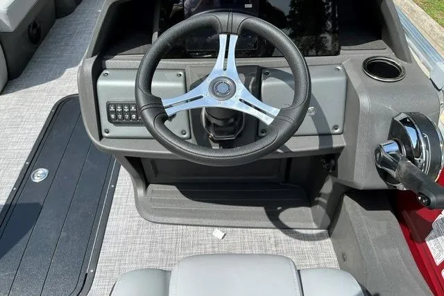 Slide: The Image of 2026 Sun Tracker SportFish 22 XP3 boat dashboard with steering wheel and controls. - 8