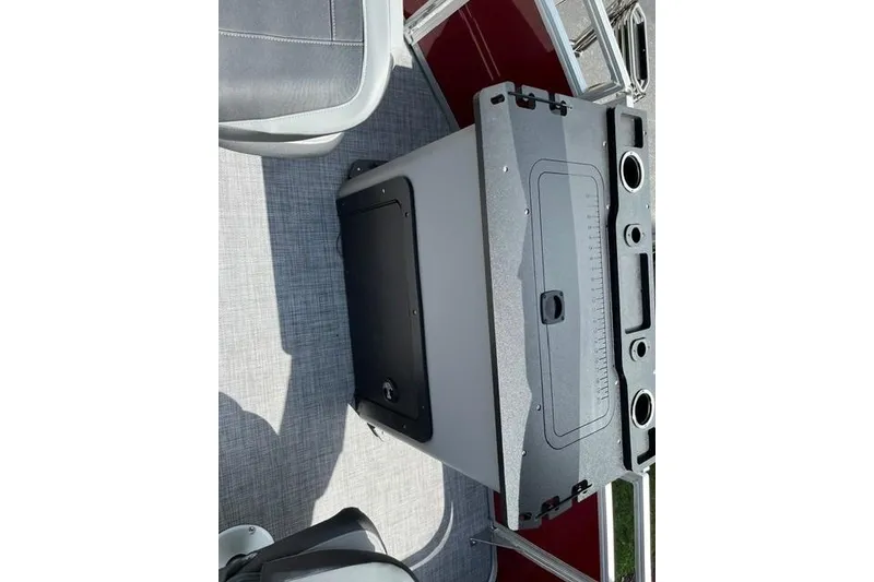 Slide: The Image of 2026 Sun Tracker SportFish 22 XP3 boat interior with seating and storage compartment. - 17