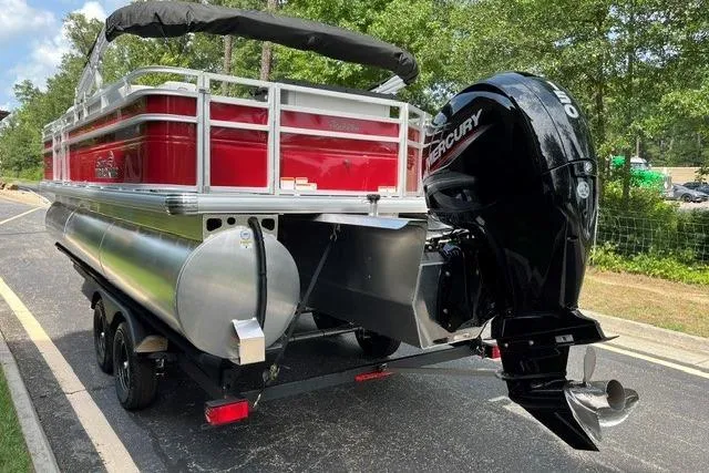 Slide: The Image of 2026 Sun Tracker SportFish 22 XP3 pontoon boat with Mercury outboard motor on trailer. - 5
