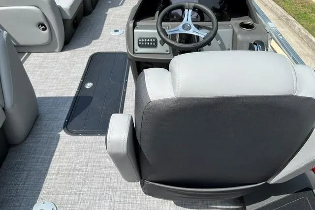 Slide: The Image of 2026 Sun Tracker SportFish 22 XP3 boat interior with steering wheel and seating. - 9