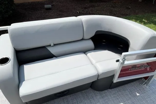 Slide: The Image of 2026 Sun Tracker SportFish 22 XP3 pontoon boat seating with gray upholstery and cup holder. - 12