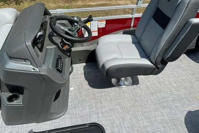 Slide: The Image of 2026 Sun Tracker SportFish 22 XP3 boat interior with steering console and captain's chair. - 11