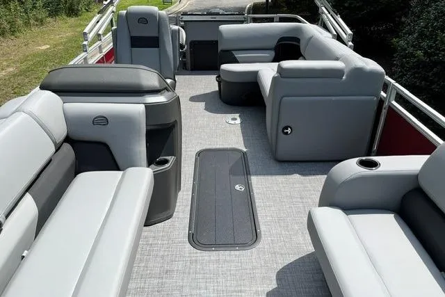 Slide: The Image of 2026 Sun Tracker SportFish 22 XP3 pontoon boat interior with gray seating and spacious layout. - 16