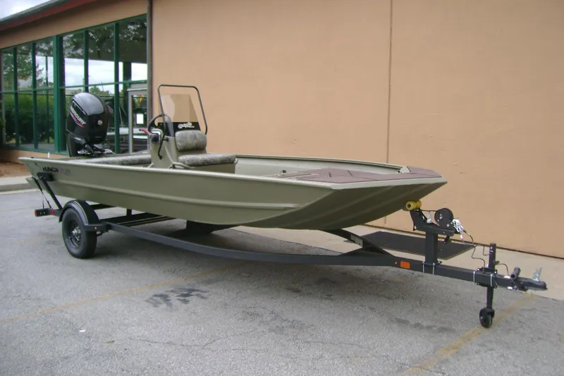 Slide: The Image of 2026 Tracker Grizzly 1860 CC boat on trailer, parked outdoors. - 2