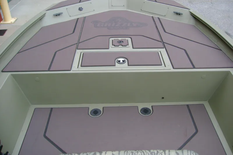 Slide: The Image of 2026 Tracker Grizzly 1860 CC boat deck with storage compartments and non-slip surface. - 10
