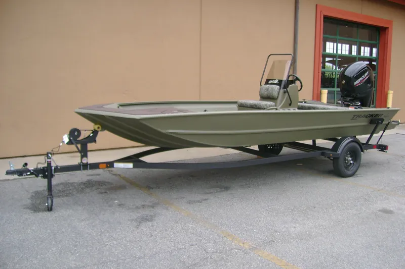 Slide: The Image of 2026 Tracker Grizzly 1860 CC boat on trailer, parked outdoors. - 3