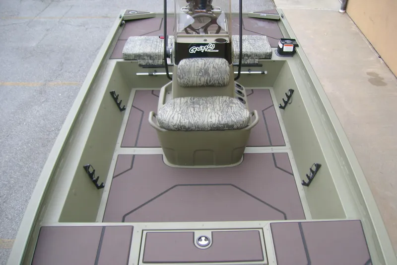 Slide: The Image of 2026 Tracker Grizzly 1860 CC boat interior with camouflage seating and spacious deck layout. - 8