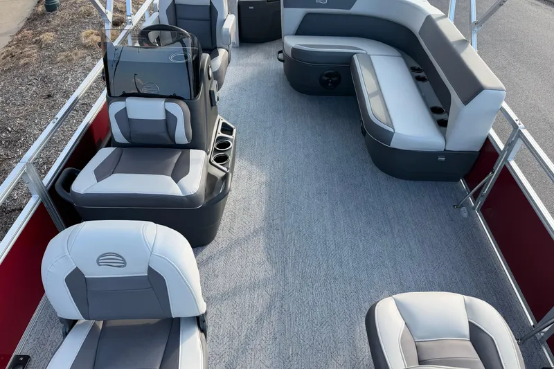 Slide: The Image of 2026 Sun Tracker Bass Buggy 18 DLX pontoon boat interior with gray seating and carpet. - 2