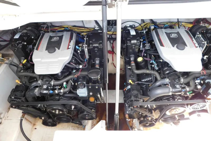 Slide: The Image of Twin engines in a 2009 Bayliner 300 boat, showcasing detailed mechanical components. - 91