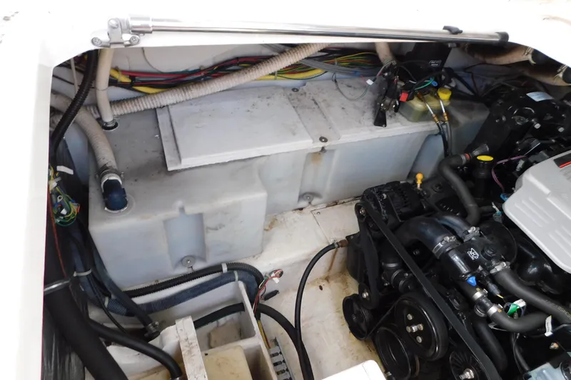 Slide: The Image of Engine compartment of a 2009 Bayliner 300 boat, showcasing mechanical components and wiring. - 95