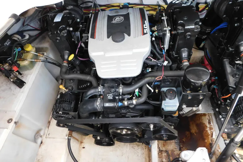 Slide: The Image of Engine compartment of a 2009 Bayliner 300 boat, showcasing the 5.0L engine. - 92