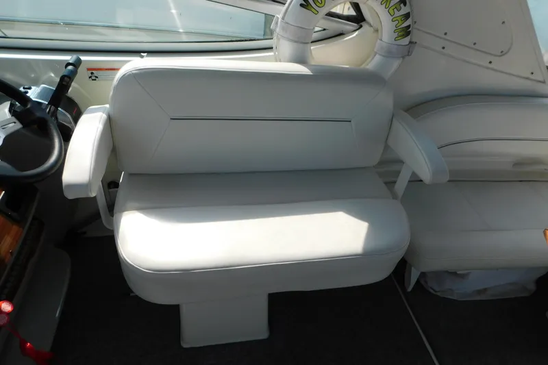 Slide: The Image of 2009 Bayliner 300 boat interior with white seating and steering area. - 30