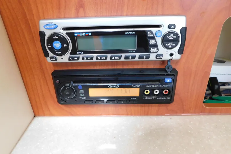 Slide: The Image of 2009 Bayliner 300 boat stereo and DVD player on wooden panel. - 65