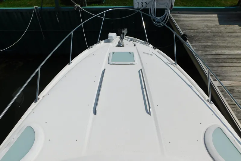 Slide: The Image of 2009 Bayliner 300 boat deck at dock, featuring sleek design and stainless steel railings. - 42