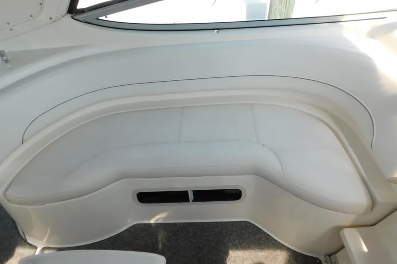 Slide: The Image of Interior seating of a 2009 Bayliner 300 boat, featuring white upholstery. - 40
