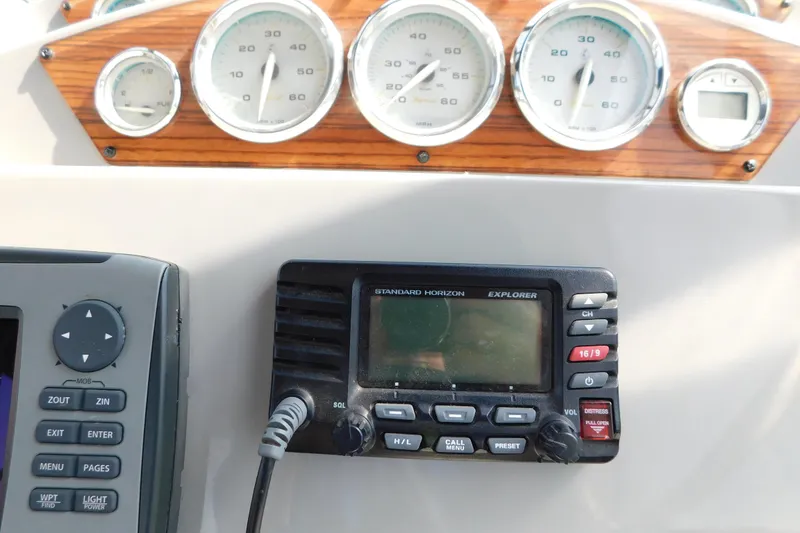 Slide: The Image of Dashboard of a 2009 Bayliner 300 boat with gauges and radio equipment. - 34