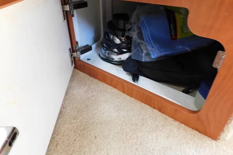 Slide: The Image of Open cabinet in 2009 Bayliner 300 boat, storing blue towels and equipment. - 75