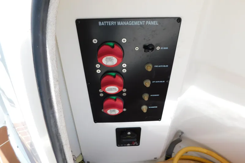 Slide: The Image of Battery management panel on a 2009 Bayliner 300 boat, featuring switches and controls. - 13