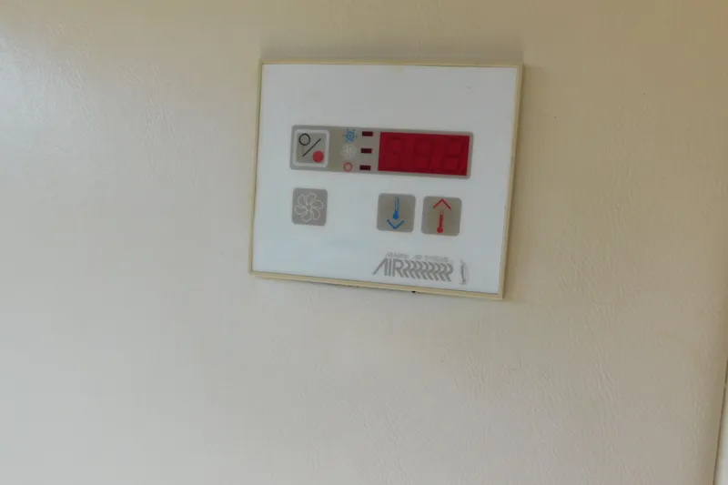 Slide: The Image of Control panel on a 2009 Bayliner 300 boat, displaying temperature settings. - 88