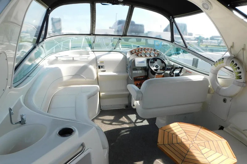 Slide: The Image of 2009 Bayliner 300 boat interior with steering wheel, seating, and dashboard controls. - 21