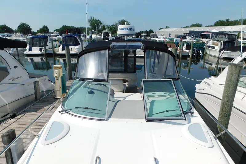 Slide: The Image of 2009 Bayliner 300 boat docked at marina, featuring sleek design and spacious cockpit. - 45