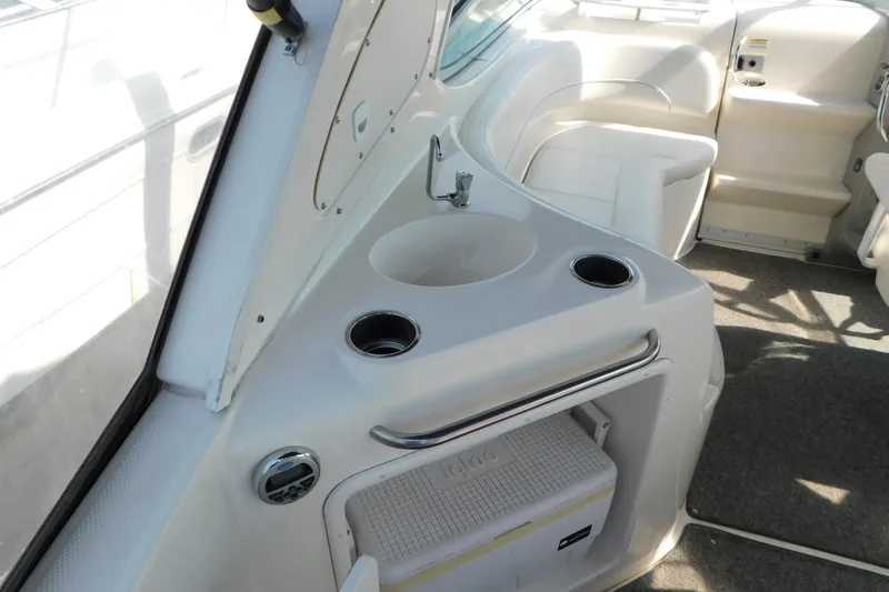 Slide: The Image of Interior of a 2009 Bayliner 300 boat featuring a sink and seating area. - 22