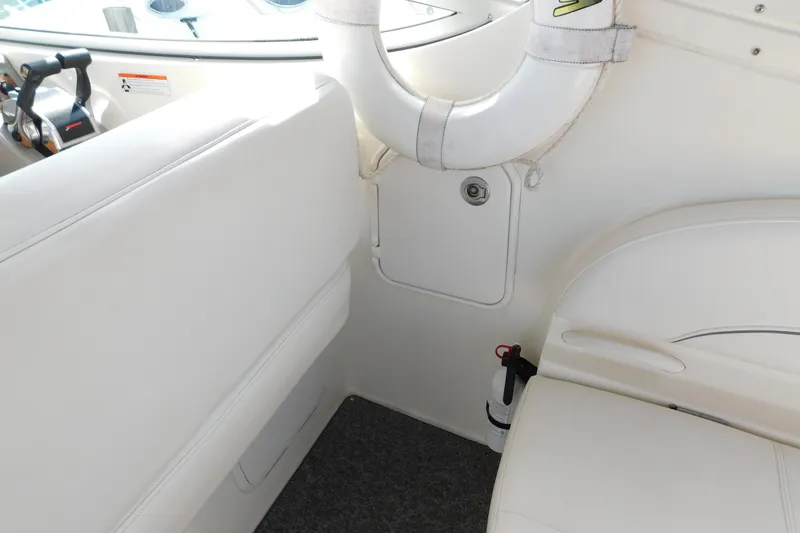 Slide: The Image of Interior of 2009 Bayliner 300 boat with white seating and safety equipment. - 24