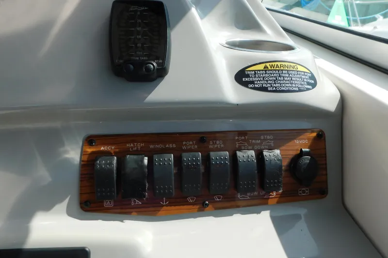 Slide: The Image of Control panel of a 2009 Bayliner 300 boat with switches and warning label. - 33