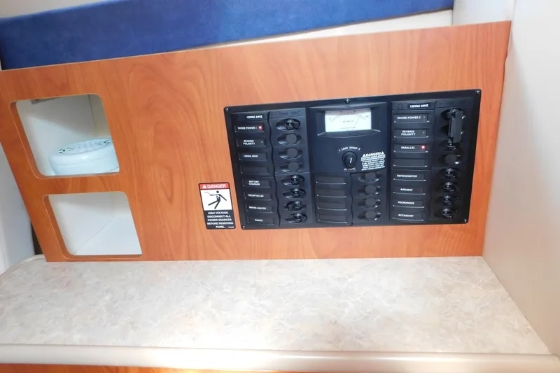 Slide: The Image of Electrical control panel in a 2009 Bayliner 300 boat interior. - 80
