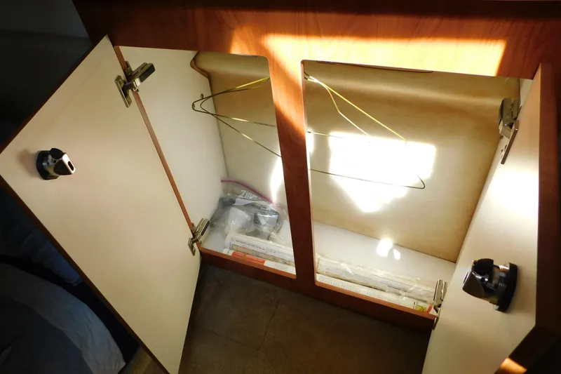 Slide: The Image of Open cabinet in 2009 Bayliner 300 boat interior, showing hangers and storage space. - 81