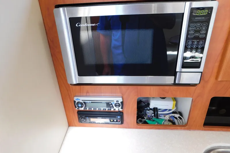 Slide: The Image of Microwave and control panel in 2009 Bayliner 300 boat interior. - 63