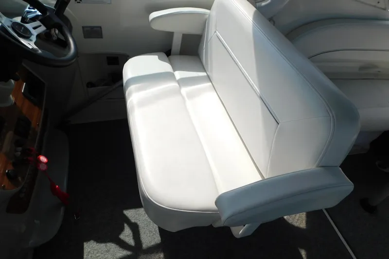 Slide: The Image of 2009 Bayliner 300 interior with white leather seating and steering wheel. - 28