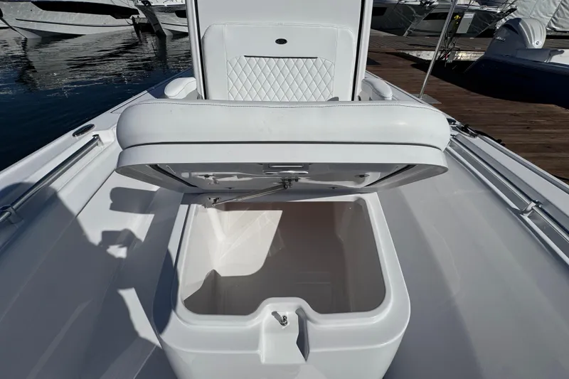 Slide: The Image of 2024 Sportsman Masters 247 Bay Boat with open storage compartment on deck. - 11