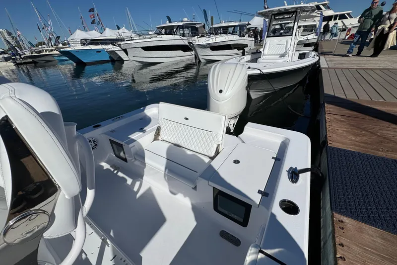 Slide: The Image of 2024 Sportsman Masters 247 Bay Boat docked at marina, showcasing sleek design and seating. - 5