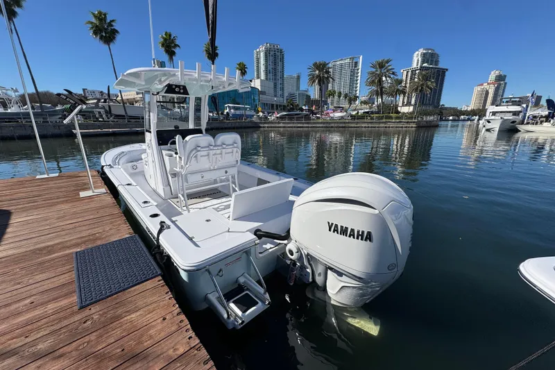 The Image of 2024 Sportsman Masters 247 Bay Boat docked with Yamaha engine, city skyline in background. - 3