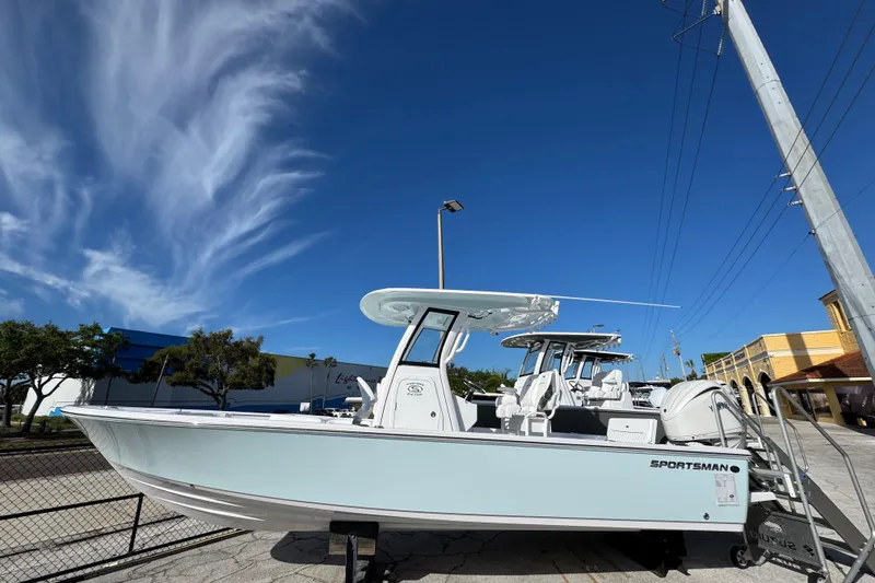 Slide: The Image of 2026 Sportsman Masters 247 Bay Boat displayed outdoors under a clear blue sky. - 1