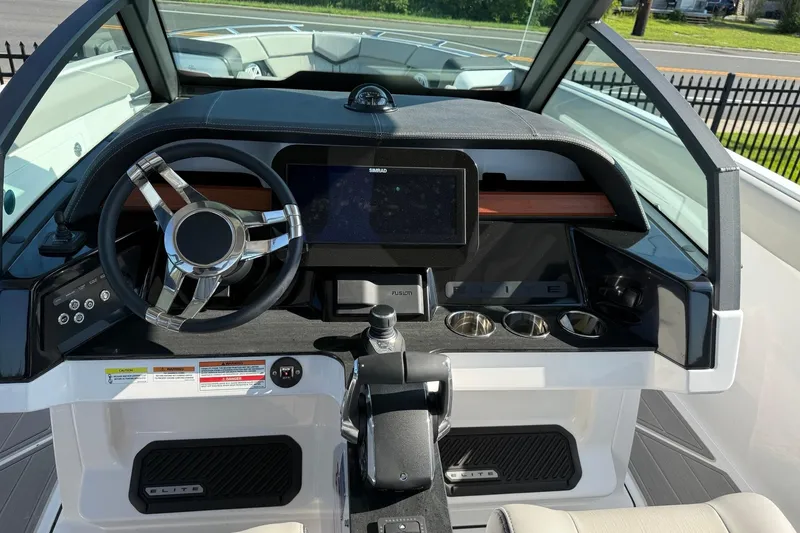 Slide: The Image of Cockpit of 2027 Monterey Elite 30 OB boat with modern steering and controls. - 10