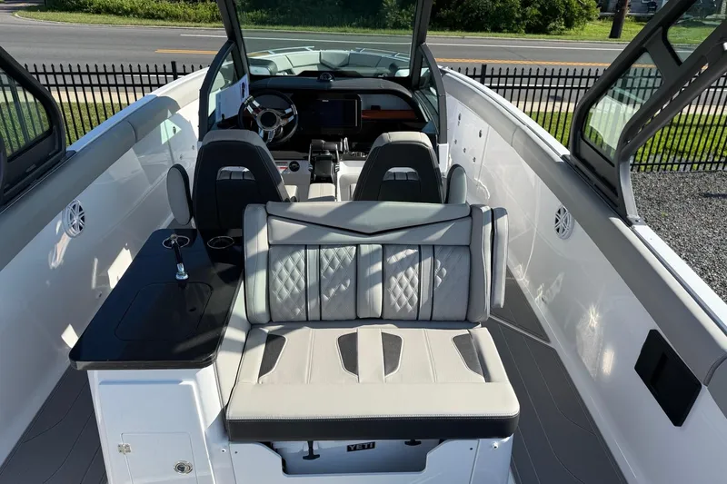 Slide: The Image of 2027 Monterey Elite 30 OB boat interior with luxurious seating and modern dashboard design. - 12