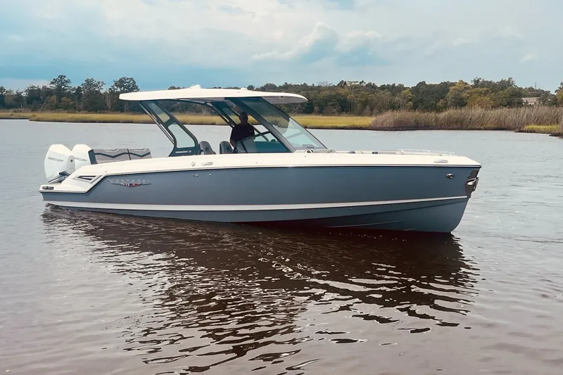 The Image of 2027 Monterey Elite 30 OB boat on calm water, showcasing sleek design and modern features. - 0