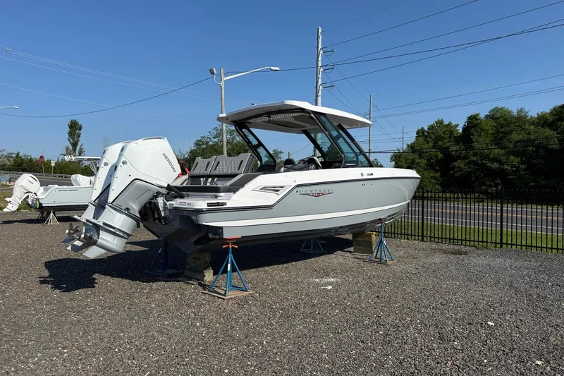 Slide: The Image of 2027 Monterey Elite 30 OB boat on display, featuring dual outboard engines. - 2