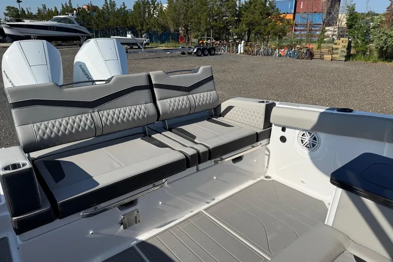 Slide: The Image of 2027 Monterey Elite 30 OB boat interior with stylish seating and dual outboard engines. - 14