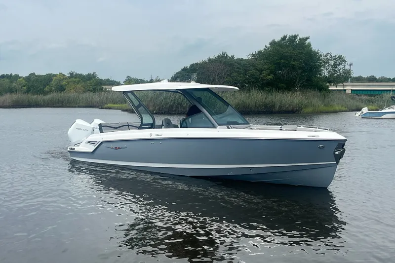 Slide: The Image of 2027 Monterey Elite 30 OB boat on calm water, showcasing sleek design and modern features. - 4