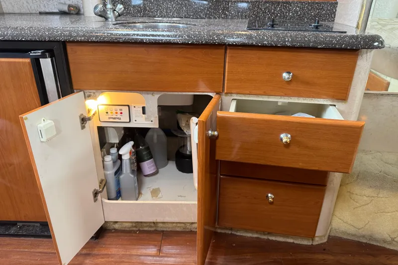 Slide: The Image of Open cabinet and drawers in 2003 Formula 37 Performance Cruiser kitchen area. - 46