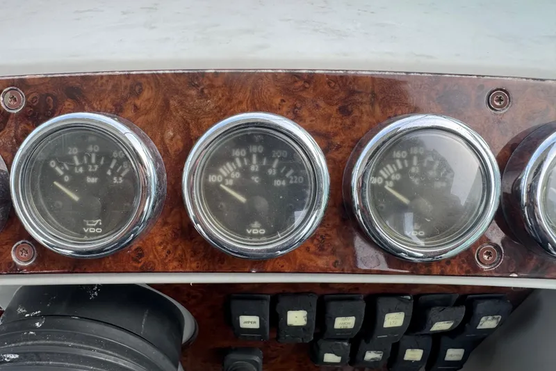 Slide: The Image of Dashboard of a 2003 Formula 37 Performance Cruiser with VDO gauges and wood paneling. - 35