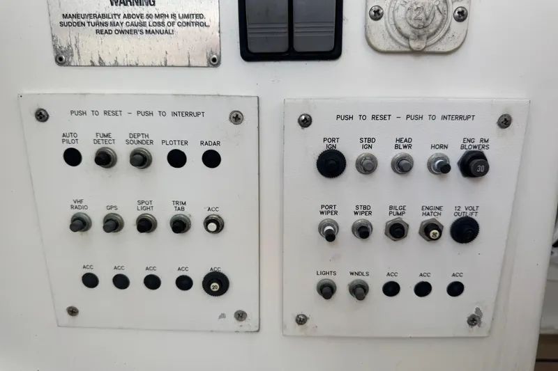 Slide: The Image of Control panel of a 2003 Formula 37 Performance Cruiser with various switches and indicators. - 64