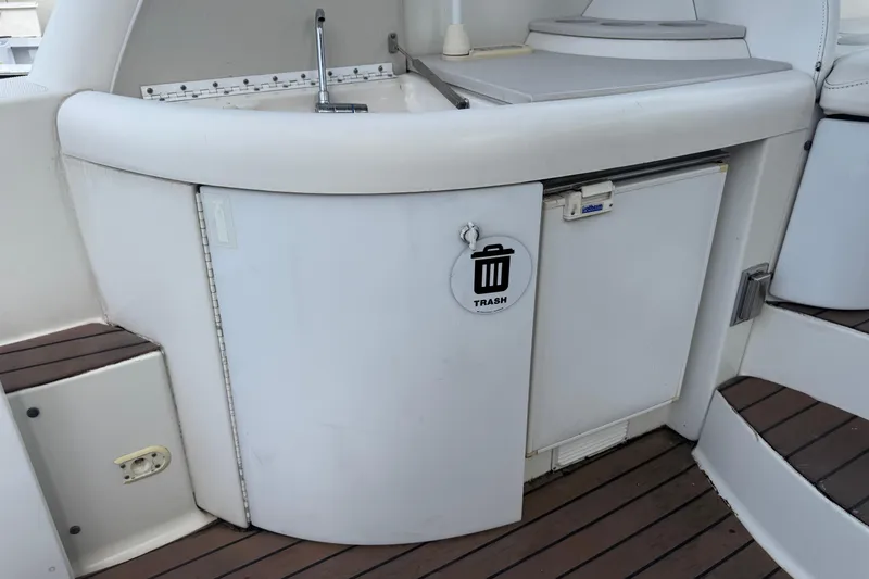 Slide: The Image of 2003 Formula 37 Performance Cruiser interior with sink, trash compartment, and wooden flooring. - 23