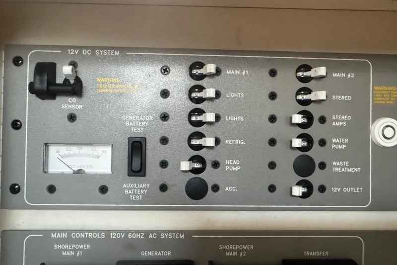 Slide: The Image of Control panel of a 2003 Formula 37 Performance Cruiser, featuring 12V DC system switches. - 50