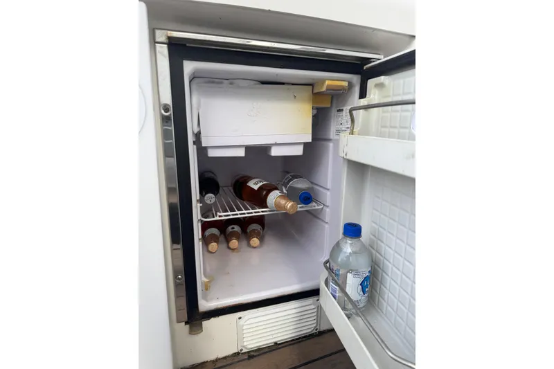 Slide: The Image of Mini fridge stocked with beverages on a 2003 Formula 37 Performance Cruiser. - 26
