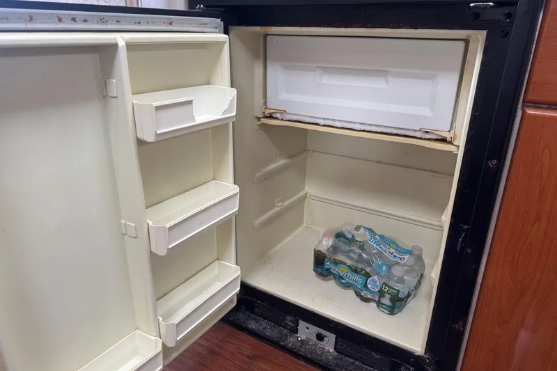 Slide: The Image of Open refrigerator in 2003 Formula 37 Performance Cruiser with bottled water inside. - 48